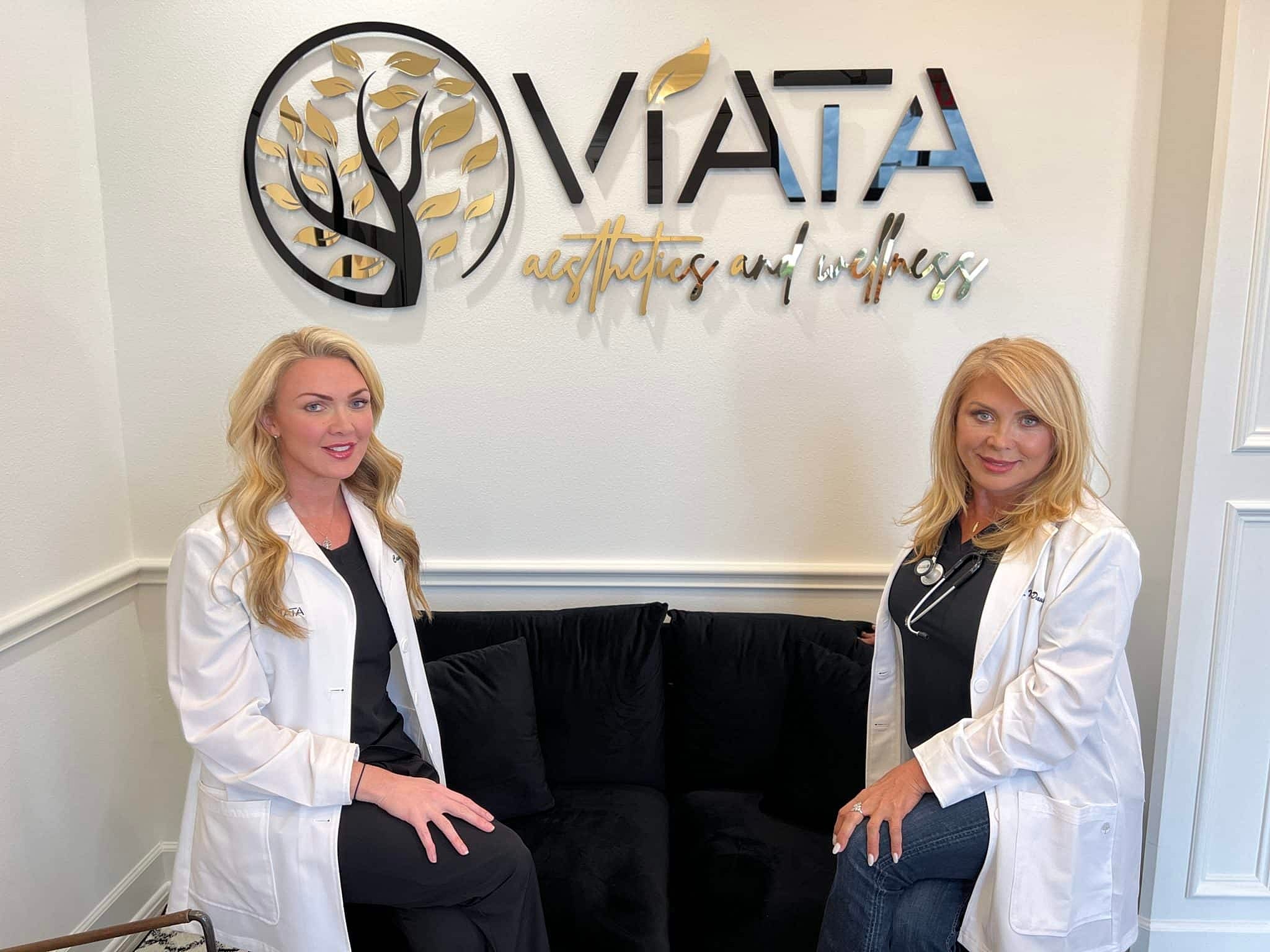 Two professionals in lab coats at wellness center.