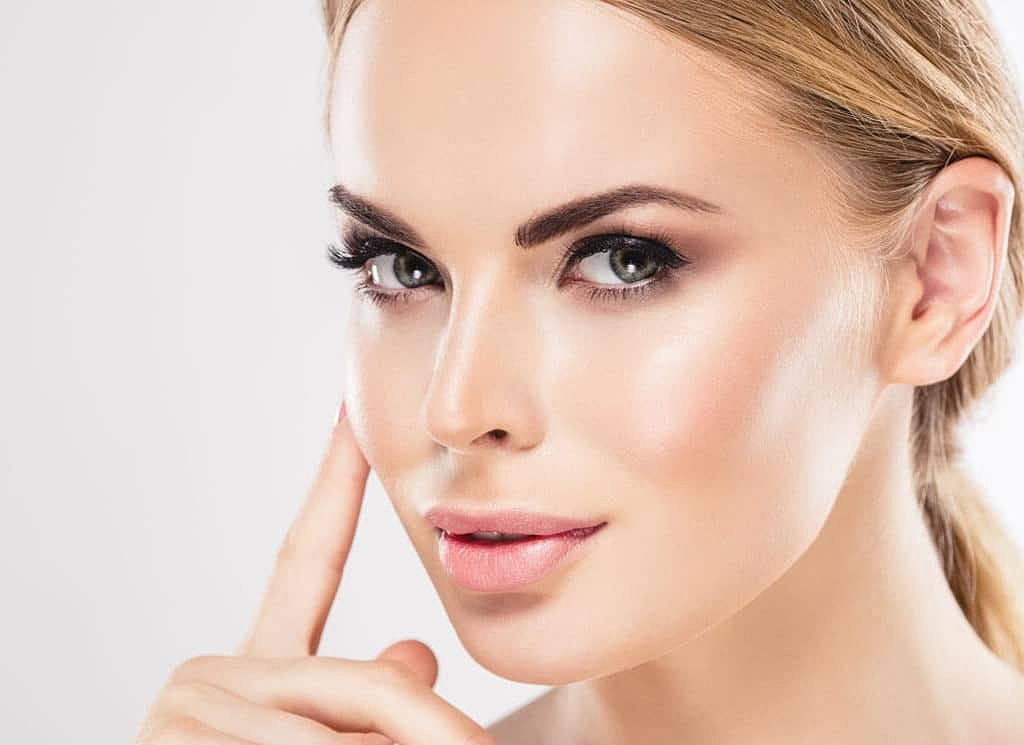 Young woman with flawless skin and makeup.