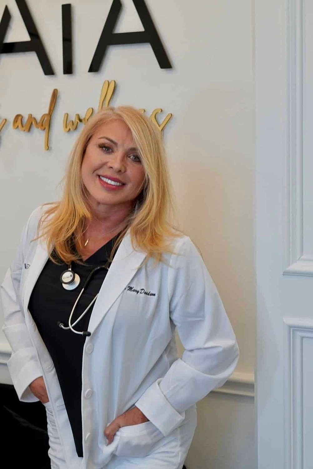 Female doctor smiling in wellness clinic environment.