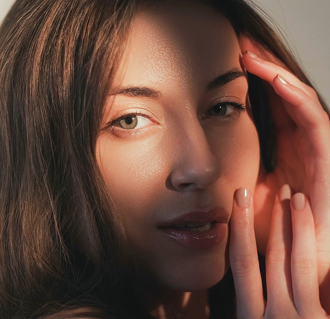 Woman's face partially illuminated by soft light.