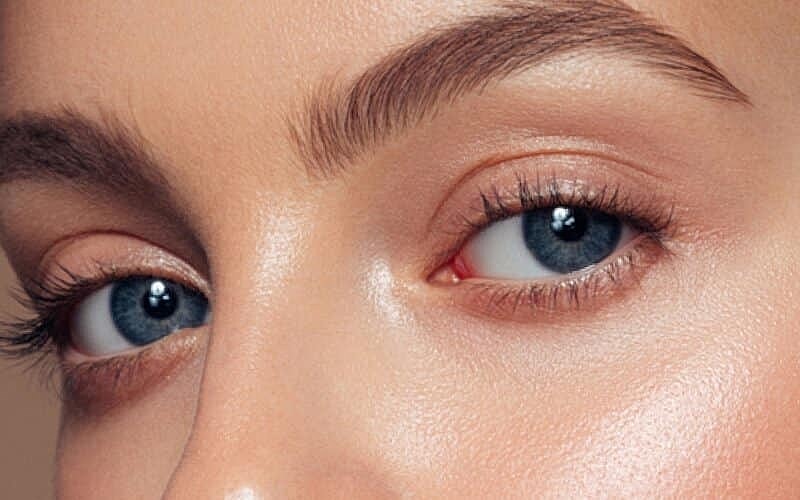 Close-up of blue eyes and flawless skin.